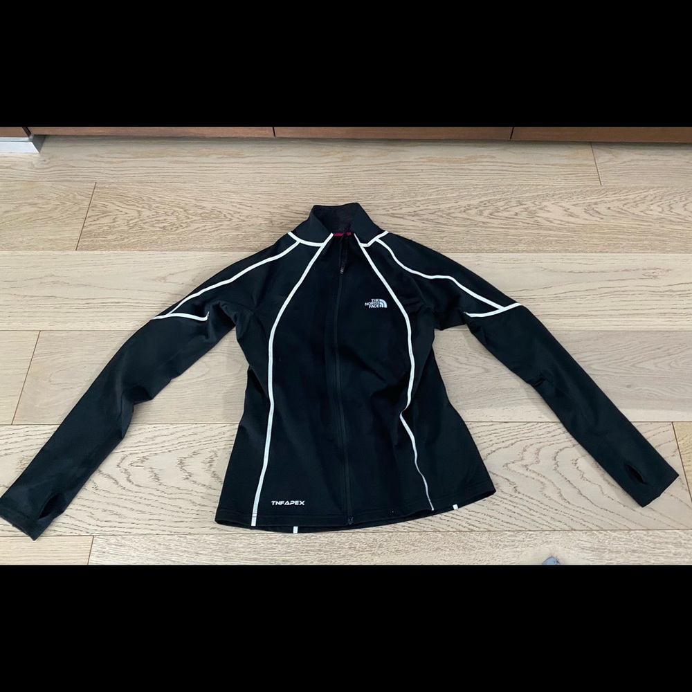 North face running jacket with reflective accent. Size medium